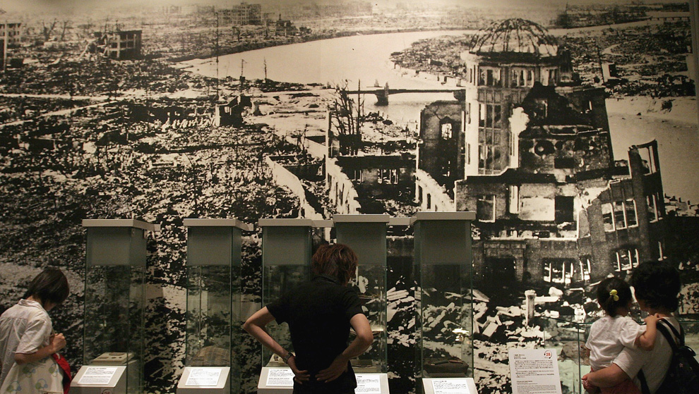 32. Посетители мемориального парка Хиросимы смотрят на панорамный вид последствий атомного взрыва 27 июля 2005 года в Хиросиме. (Photo by Junko Kimura/Getty Images)