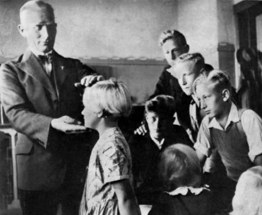 Немецкий врач измеряет параметры головы белокурых детей в рамках расовой селекции