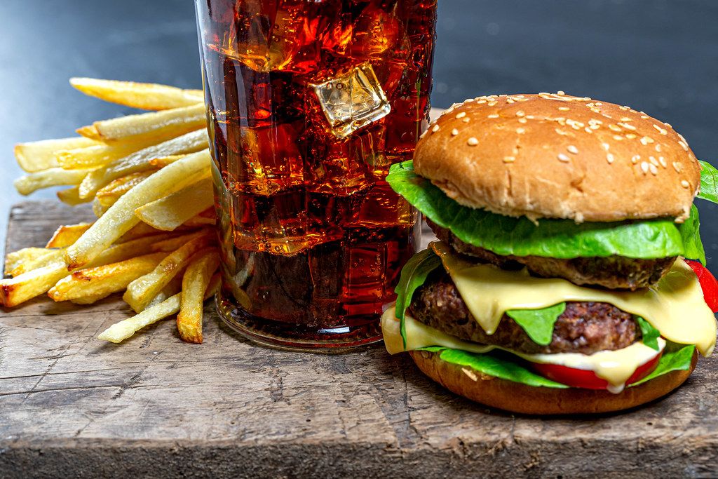 Bigpicture ru 1602328584 glass of cola with ice french fries and burger close up