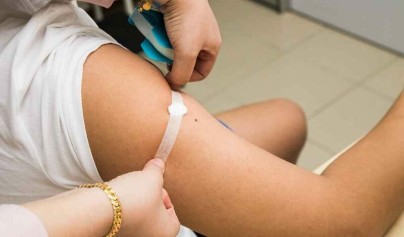 Bigpicture ru doctor attaching a plaster onto patient arm after pbqqzap 1024x600