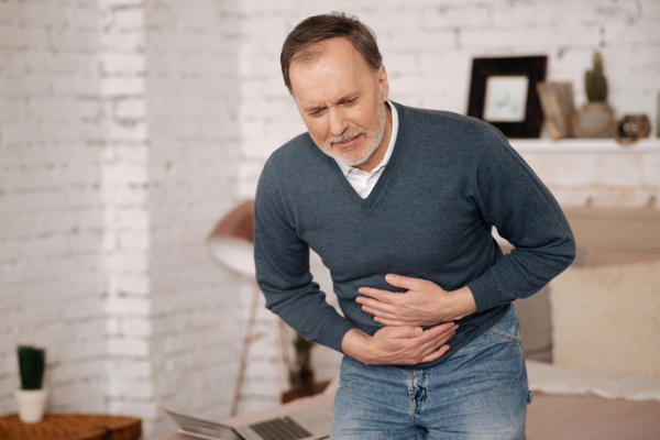 Old man feeling big discomfort in stomach