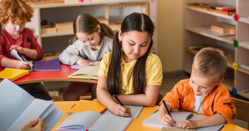 Bigpicture ru stock photo multiethnic kids writing notebooks lesson