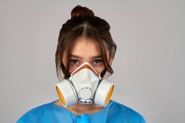Portrait of a young girl wearing respiratory mask to protect from coronavirus.