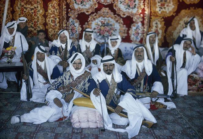 Armed bedouin beni sakhr chiefs await their king's visit.