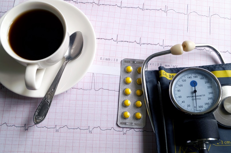 Hemopiezometer for measuring blood pressure, cup of coffee, pill