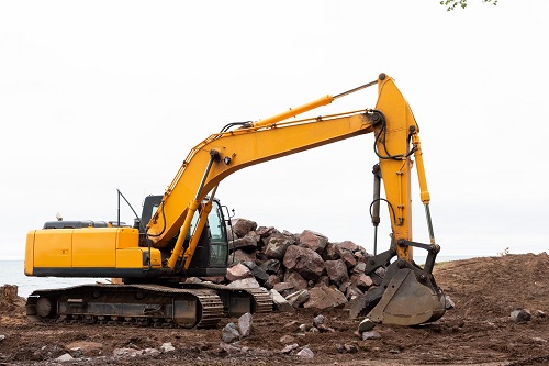 Excavator along shoreline on lake superior