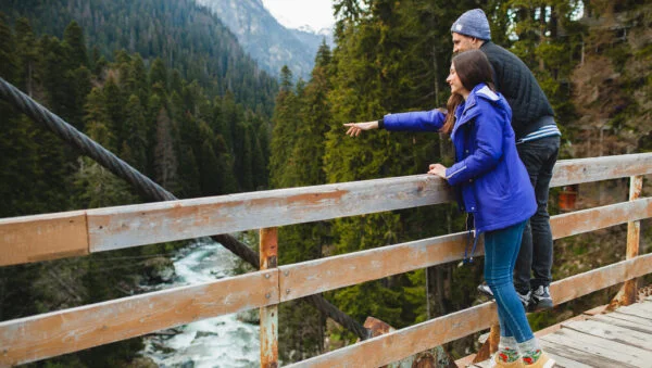 Young hipster beautiful couple love winter forest winter vacation mountains 600x339