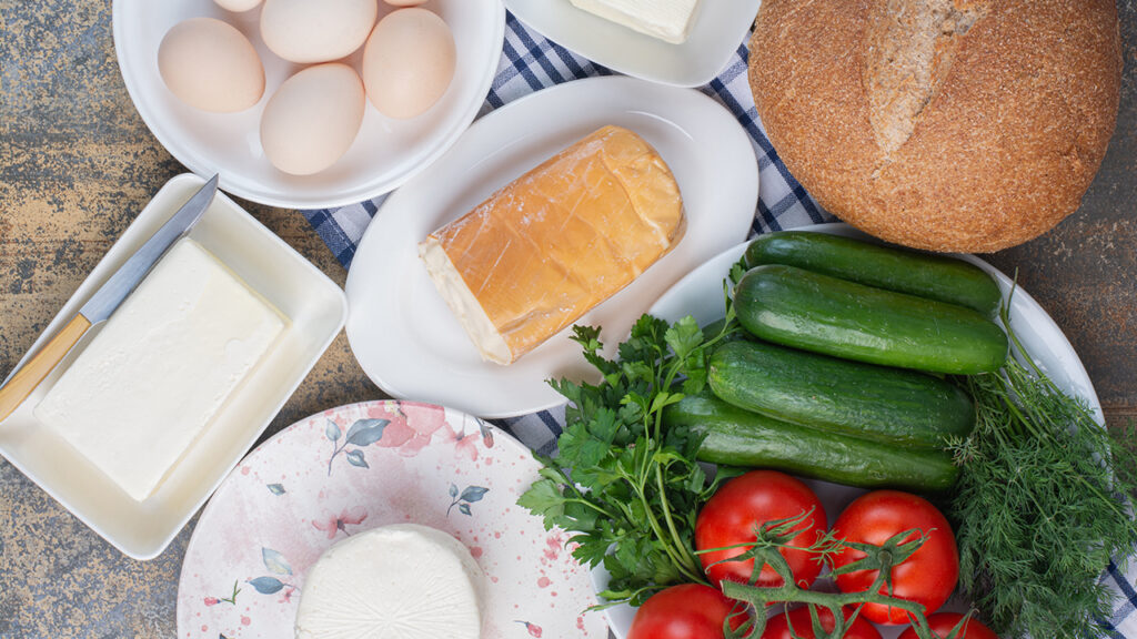 Dairy products, bread and vegetables for breakfast