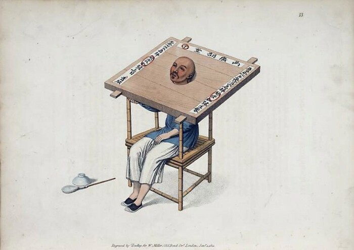 Осуждённый в неудобной колодке с острым краем, рядом на земле стоят чашка и мухобойка, до которых он не может дотянуться.