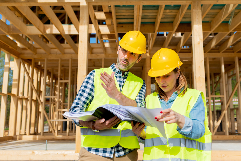 Construction,engineer,and,architect,consult,plans,on,building,site,of