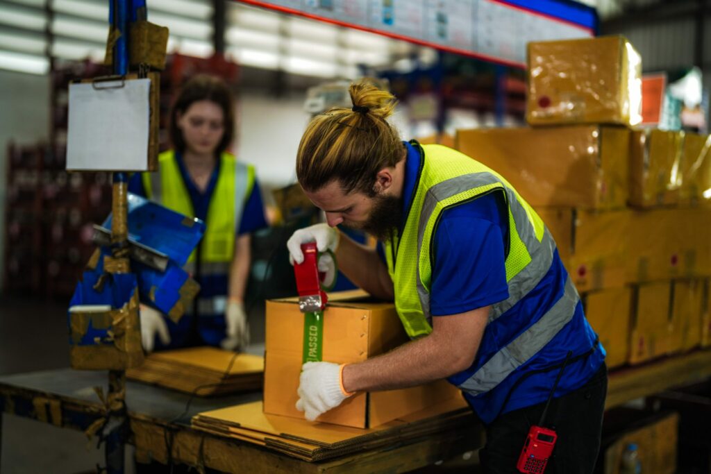 Bigpicture ru warehouse worker folding paper box for packing the 2025 04 13 02 33 33 utc min scaled