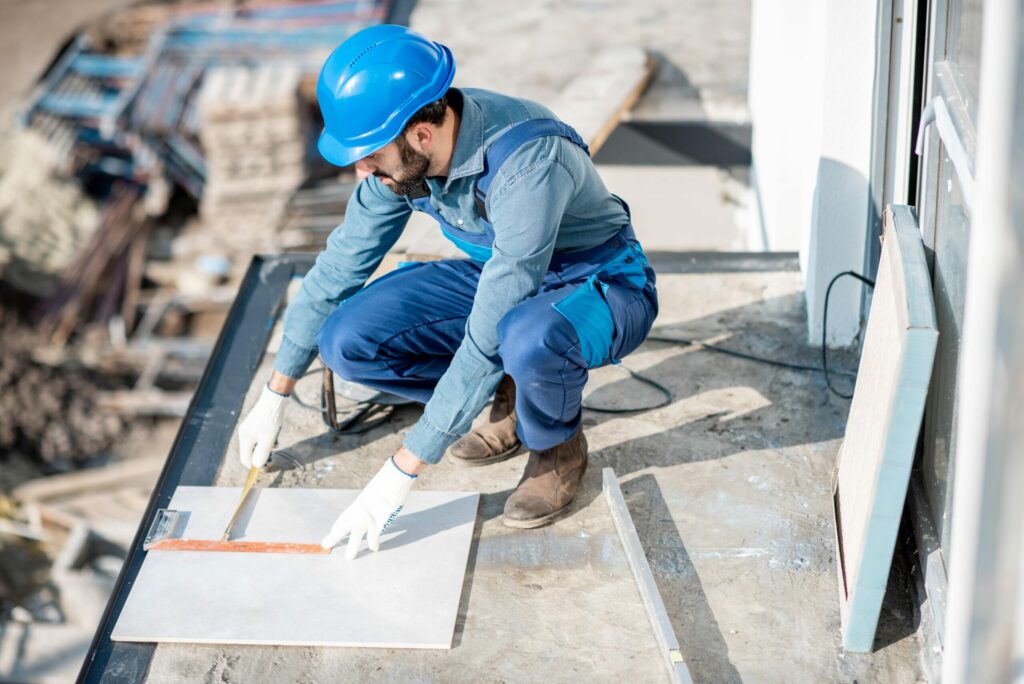 Bigpicture ru workman laying tiles on the balcony 2025 03 15 06 05 21 utc min scaled