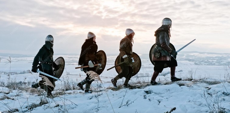 Люди в средневековых доспехах на фоне заснеженного пейзажа