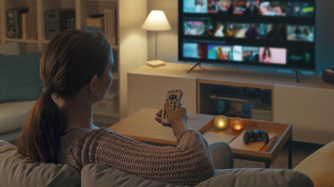 Woman watching tv at home and relaxing