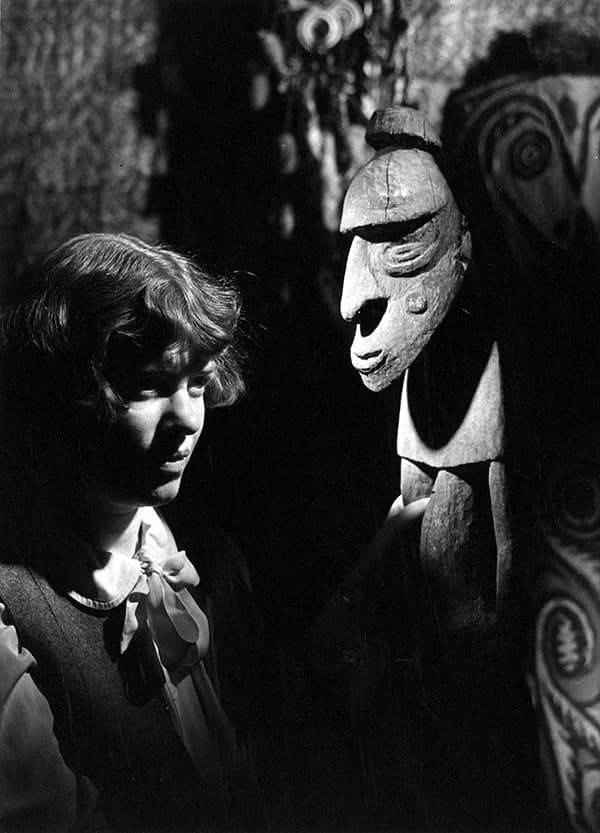Молодая Маргарет Мид стоит рядом с племенной маской во время экспедиции 1930 год