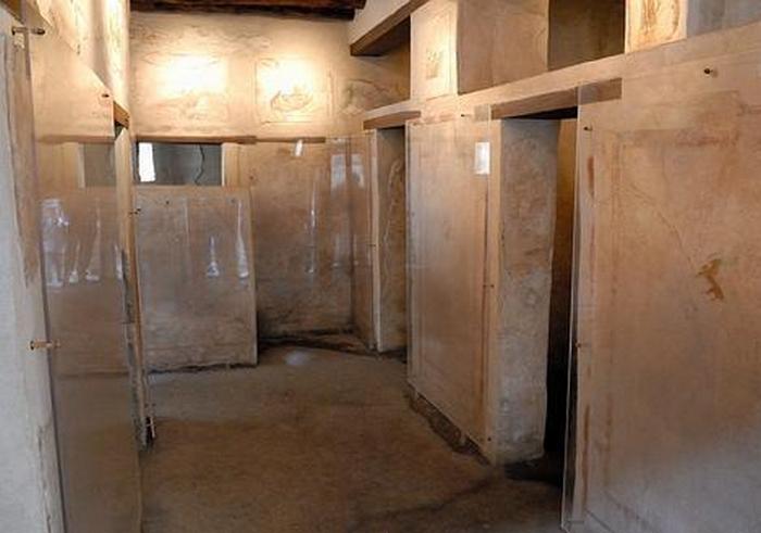 Коридор лупанария в Помпеях с фресками и дверными проёмами кубикул без занавесок