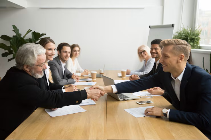 Bigpicture ru senior investor buying startup handshaking young entrepreneur group meeting 1163 4888